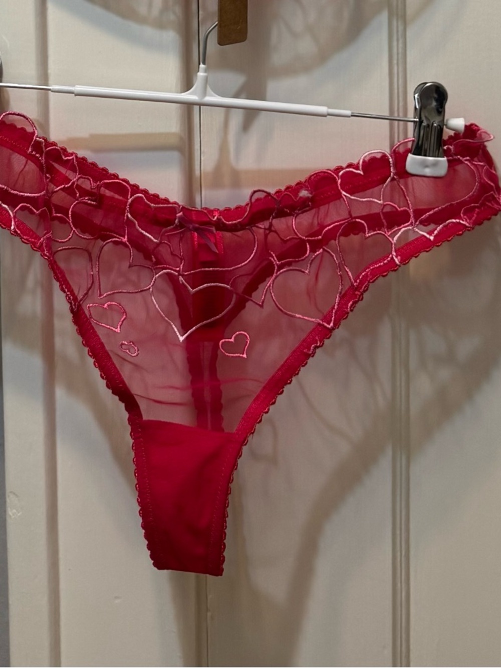 Skims heart embroidered unlined tulle thong. Punch color. NWOT